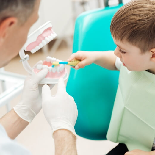 Child practicing tooth brushing dental checkup and teeth cleaning visit