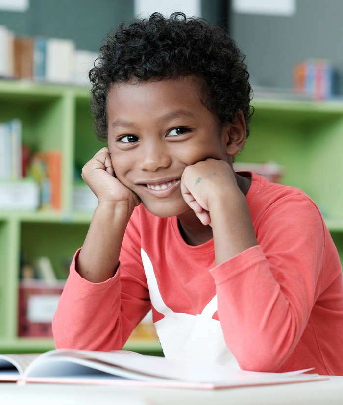 Child with dental sealants smiling