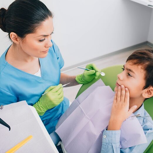Child in pain before receiving emergency kids' dentistry