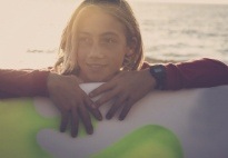 Child holding a surfboard