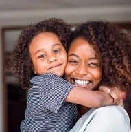 Mother and child smiling together after sedation dentistry visit