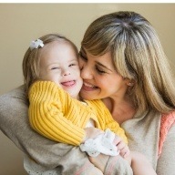 Mother kissing child's cheek after special needs dentistry visit