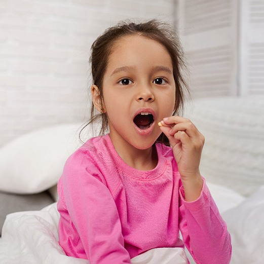 Child holding pill