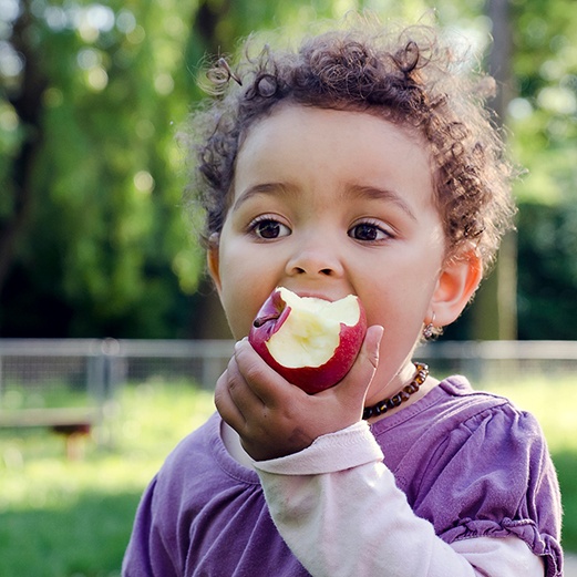 Little boy eating an apple after visiting emergency dentist in Papillon, NE