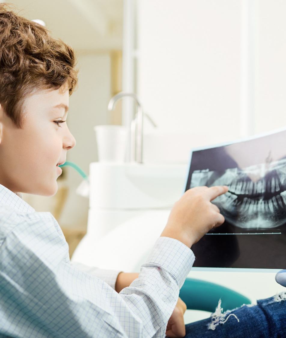 toddler looking at x-ray from pediatric dentist in Papillion