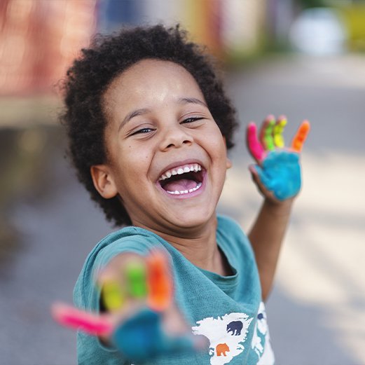 Child laughing after tooth extractions