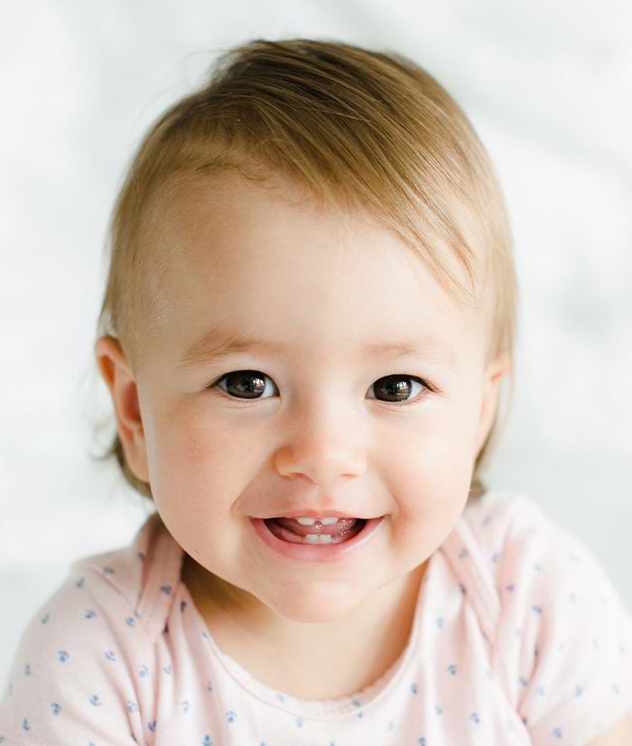 Baby sharing healthy smile after receiving dentistry for infants