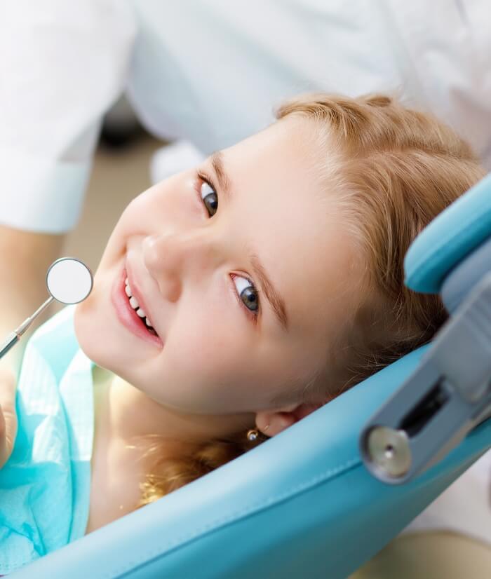 Young child smiling while receiving dentistry for toddlers