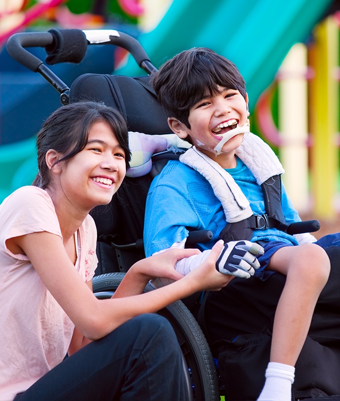 Two young people smiling after special needs dentistry visit