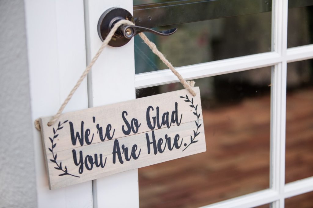 We're so glad you are here sign on door