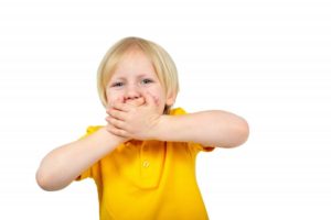 worried boy covering mouth 