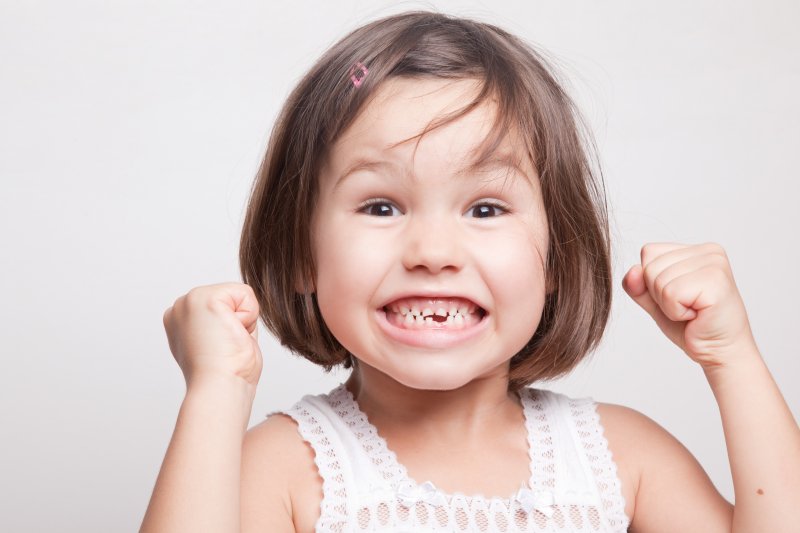 excited child with a missing tooth