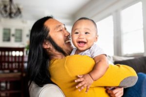 a father holding his baby