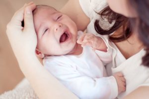 Mother holding her crying baby