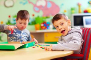 Two special needs children playing with toys