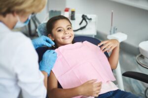 Young kid smiling at the dentist