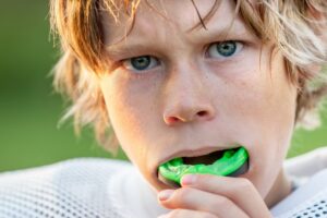 Young boy with mouthguard in.
